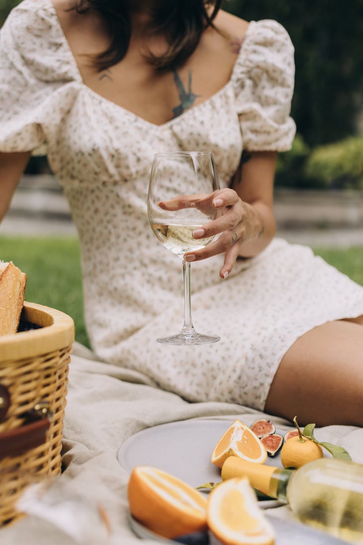 Woman with wine and Fruits on a Picnic