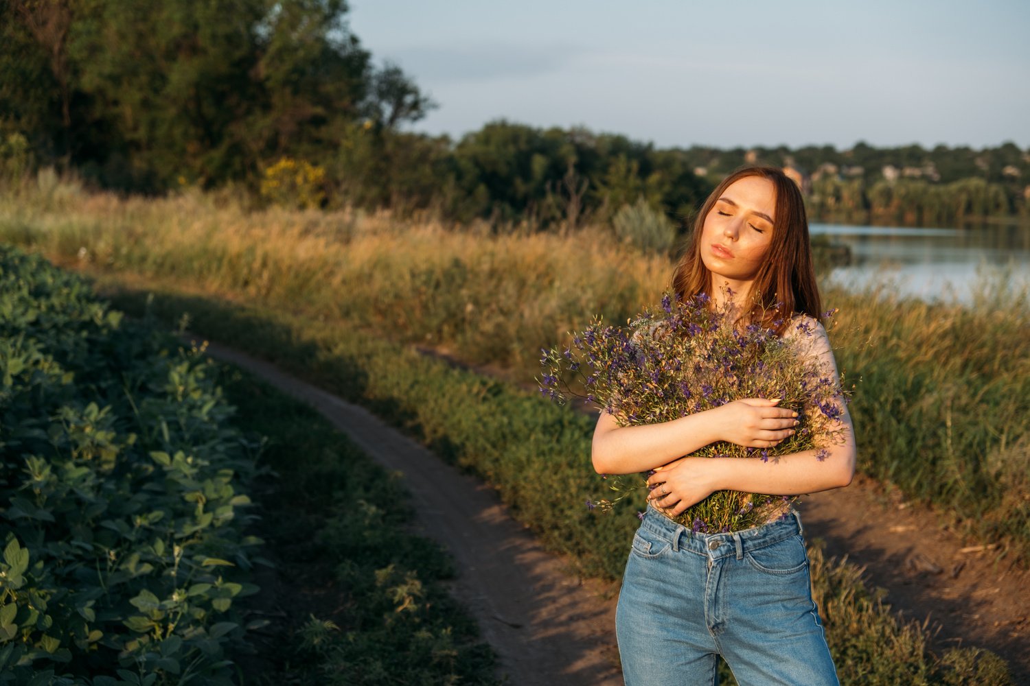 Celebration of Self, inner beauty, self-love, self-soothing, self-celebration. Happy young girl holding wildflowers bouquet, relaxing and enjoying life